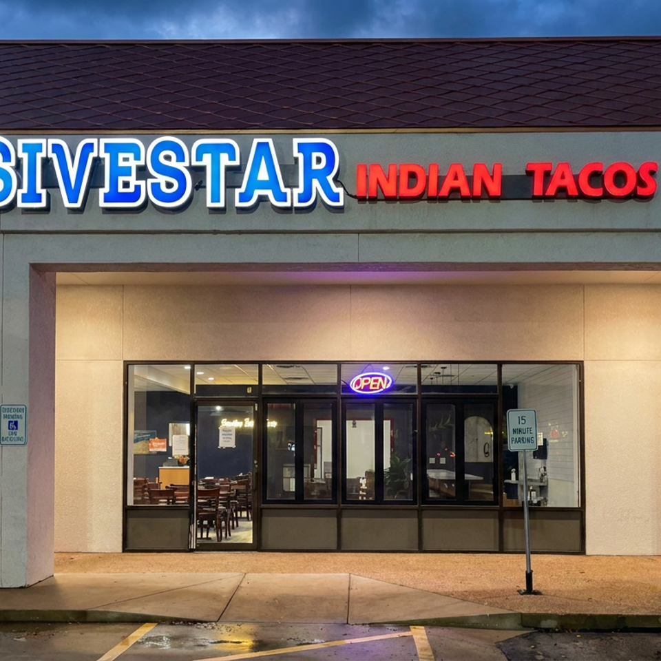 This is a real photograph of the storefront of a restaurant called 'Sivestar Indian Tacos' at dusk.